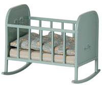 Delightful Maileg Cradle, My in blue mint—a miniature rocking crib with ornate sides, patterned mattress, and pillow—perfect for imaginative play by Maileg.