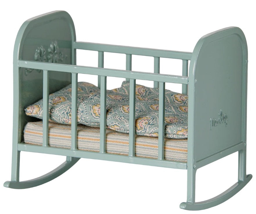 Delightful Maileg Cradle, My in blue mint—a miniature rocking crib with ornate sides, patterned mattress, and pillow—perfect for imaginative play by Maileg.