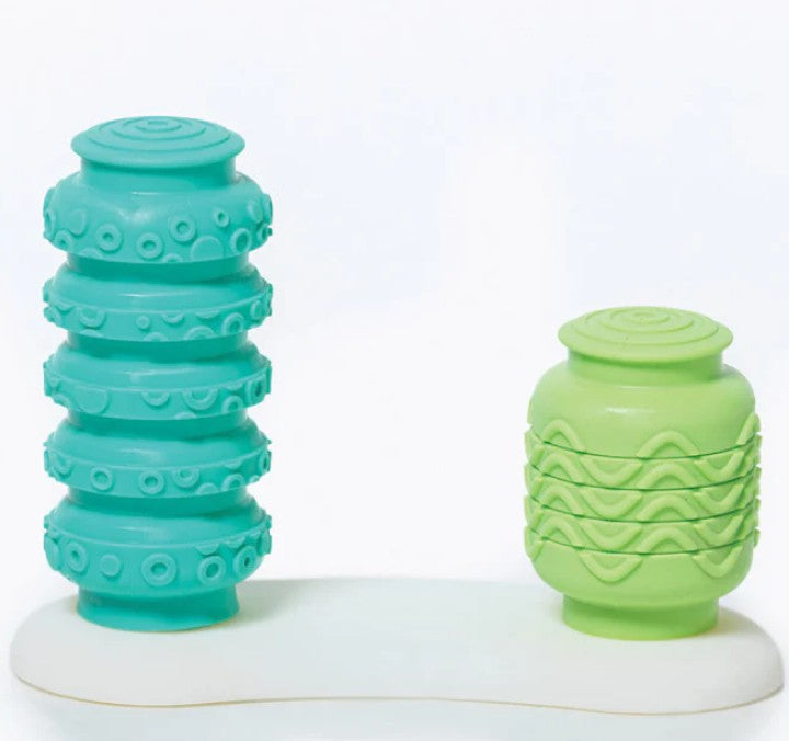 Smart Toys’ Krumples Bop & Pop! Green/Teal features two textured silicone jars—a tall teal one with dot patterns and a short light green one with waves—on a white base, perfect for active family fun.