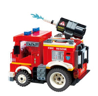 The Alpha Toys Firetruck by Alpha Toys is built from interlocking building bricks and features a water cannon on top that shoots blue water, FIRE RESCUE text on the side, and emergency lights on the roof—perfect for rescue missions and RC-style play.