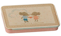 The Maileg Metal box with sliding lid - Mice by Maileg features two adorable cartoon mice in striped shirts holding a heart, framed by a decorative border and the Limited Edition label. This delightful small rectangular tin is ideal for fans of the Maileg mouse collection or anyone seeking a whimsical metal box to store tiny treasures.