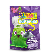 Art Creativity’s Ooey Gooey Slime Surprise comes in a purple package, featuring a cheerful green slime character sporting a chef’s hat and holding a silver platter. This playful slime container invites kids ages 3+ to uncover the mystery slime inside—just remember, while it looks delicious, it’s not food!.