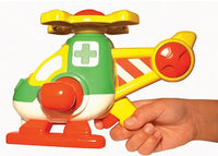 A child's hand holds the Smart Toys Harry Copters Animal Rescue play set, featuring a colorful helicopter with a green cross, yellow top rotors, and red and yellow accents.