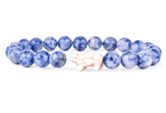 The fahlo Venture - Igloo Polar Bear bracelet features round blue marbled beads and a central white polar bear bead, ideal for wildlife conservation fans and inspired by popular animal-themed jewelry.