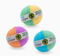 The Mystery Real Money Bath Bomb Surprise by Purposeful Bliss - Fizzy Magic includes three vibrant bombs—green/yellow, orange/purple, and blue/yellow—each labeled to hint at real cash prizes hidden inside.